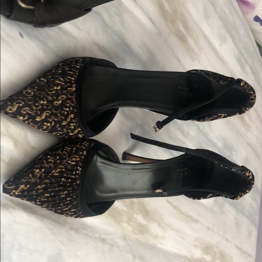 Three pairs of Gucci shoes.
